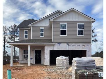 New two-story home with gray siding, white trim, and an attached two-car garage at 127 Silverton Dr, Dacula, GA 30019