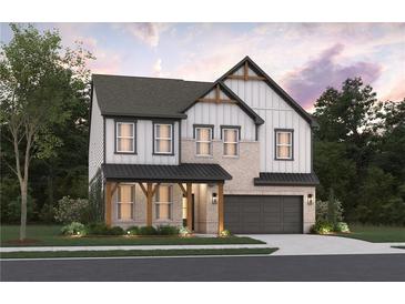 Charming two-story home with brick and siding, inviting covered porch and attached garage at 7685 Homer Dr, Cumming, GA 30028