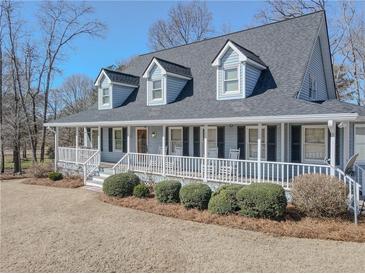 Charming two-story home features a welcoming full front porch and dormer windows at 3179 Meadow Trl, Loganville, GA 30052