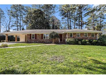 Charming brick home with a well-maintained lawn and a convenient covered carport at 2436 Hazelwood Ne Dr, Atlanta, GA 30345