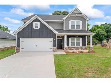 Beautiful two-story home featuring a gray color scheme, well-kept lawn, and two-car garage at 11204 Cornerstone Way, Hampton, GA 30228