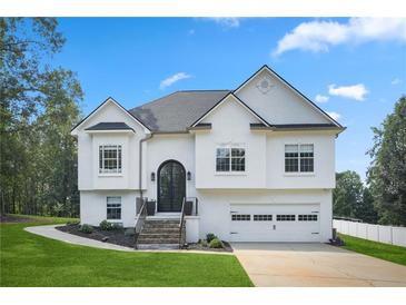 A charming two-story home with a well-maintained front yard and inviting entrance at 136 Huntcliff Trl, Ellenwood, GA 30294