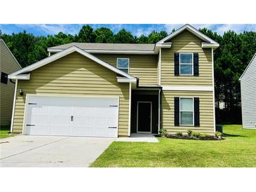 Charming two-story home featuring a two-car garage, and a well-maintained lawn at 4417 Belcamp Rd, Fairburn, GA 30213