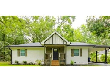 Charming renovated home with a well-maintained lawn, wood trim, and ample natural light at 2410 Macon Sw Dr, Atlanta, GA 30315