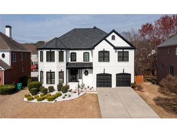 Stunning two-story home boasts a manicured front yard and a two-car garage in a quiet neighborhood at 5004 Duxford Se Dr, Smyrna, GA 30082