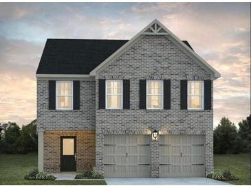 Charming two-story brick home featuring a two-car garage and well-manicured landscaping at 5320 Tolar Rd, South Fulton, GA 30213