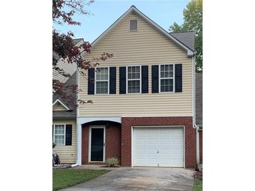 Charming home with a brick facade, a single-car garage, and classic black shutters at 6706 Sunset Valley Cir, Rex, GA 30273