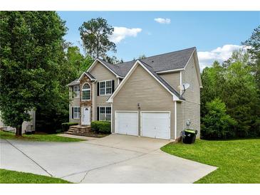 Charming two-story home with stone accents, two-car garage, and well-manicured lawn at 4240 N Braves Cir, Douglasville, GA 30135