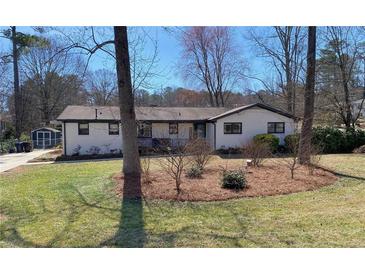Charming ranch-style home with a beautifully landscaped front yard and a well-maintained lawn at 170 Dillard Ne Dr, Kennesaw, GA 30144