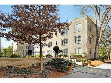 Low angle view of a three story apartment building with mature landscaping at 30 Collier Nw Rd # 6, Atlanta, GA 30309