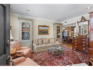 Inviting living room with bookshelves, a plush sofa, area rug and elegant furnishings at 30 Collier Nw Rd # 6, Atlanta, GA 30309
