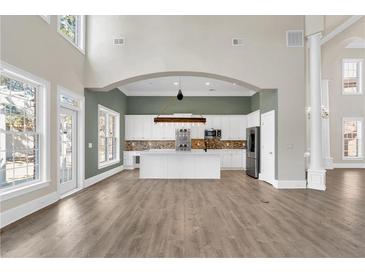 A spacious, open-concept kitchen with a large island, stainless steel appliances, and modern finishes at 360 Wembley Cir, Atlanta, GA 30328