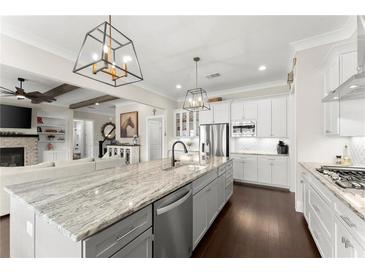 Spacious eat-in kitchen with large center island, stainless appliances, and modern lighting at 2903 Eva Clb, Acworth, GA 30101