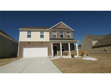 Two-story home with brick and siding exterior, two-car garage, and landscaped front yard at 1603 Maston Rd, Auburn, GA 30011