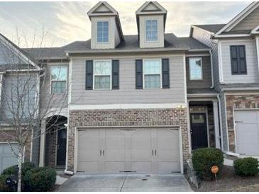 Charming two-story townhome featuring an attached two-car garage and inviting facade at 5008 Whiteoak Pointe Se # 15, Smyrna, GA 30080