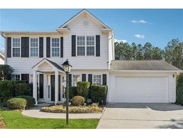 Charming two-story home with black shutters, landscaped yard, and attached two-car garage at 4030 Brushy Creek Way, Suwanee, GA 30024