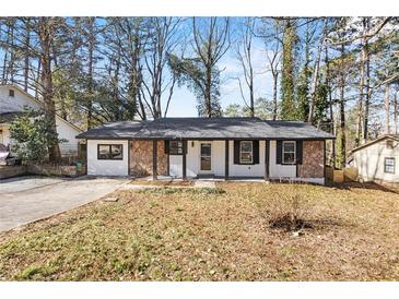 Charming single-story home featuring stone accents, a new roof, and a cozy front porch at 1400 Reddington Ln, Norcross, GA 30093