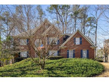 Charming brick home with manicured front yard and mature trees in a desirable neighborhood setting at 2212 Austin Lake Se Dr, Smyrna, GA 30082