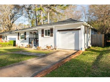 Charming single-story home with a brick-lined driveway and well-maintained front lawn at 2886 Salmon Se Ave, Atlanta, GA 30317