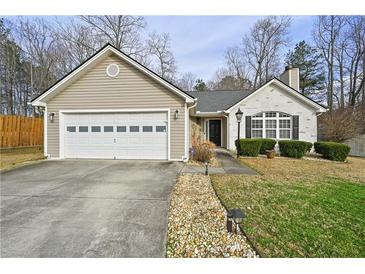 Charming single-story home with neutral siding, brick accents, and a well-maintained front lawn at 1715 Fort Daniels Trl, Dacula, GA 30019