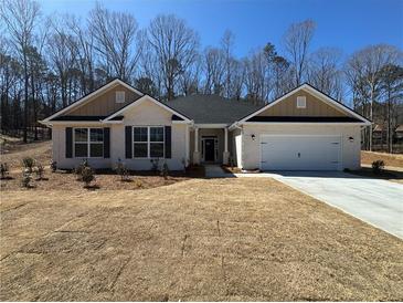 Charming single-story home with a brick facade, two-car garage, and manicured front yard at 5311 Tuscany Drive, Douglasville, GA 30135