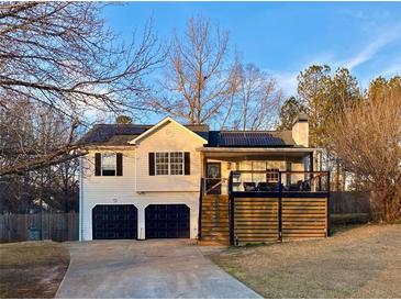 Charming home featuring a garage and modern deck in a residential neighborhood at 71 Riverside Ct, Douglasville, GA 30134