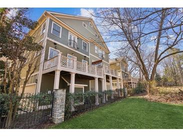 Charming multi-story home with a spacious deck perfect for outdoor entertaining and manicured lawn at 556 Moreland Ne Ave # J, Atlanta, GA 30307