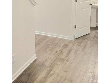 Bright hallway features hardwood flooring, fresh paint, and white trim at 680 Sundial Ln, Mableton, GA 30126