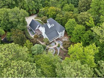 Stunning aerial view of a modern home surrounded by lush greenery and professionally landscaped gardens at 5323 Presley Pl, Douglasville, GA 30135