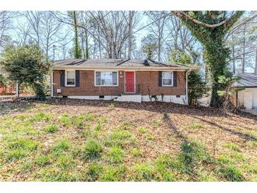 Charming single-story brick home with a red front door and well-maintained landscaping at 3119 Bellgreen Way, Decatur, GA 30032