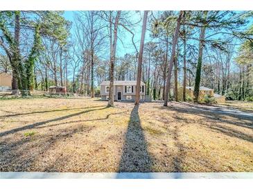 Charming home featuring a well-maintained yard, mature trees, and a classic facade at 3524 Exeter Ct, Snellville, GA 30039