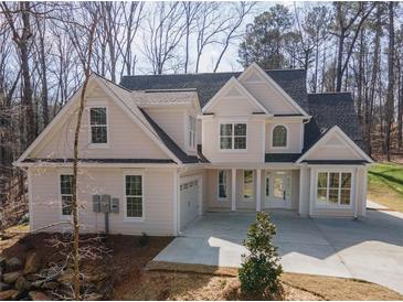 Charming two-story home with attached garage and inviting front entrance nestled in a wooded lot at 255 Olde Oak Dr, Jonesboro, GA 30238