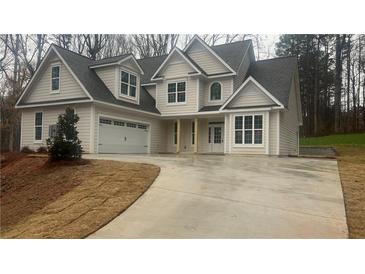 Charming two-story home with a two car garage and a long concrete driveway at 255 Olde Oak Dr, Jonesboro, GA 30238