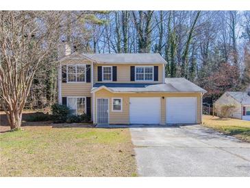 Charming two-story home with a two-car garage and neutral paint at 554 Sherwood Oaks Rd, Stone Mountain, GA 30087