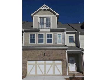Charming townhome showcasing a brick facade and a private balcony at 1935 Manor Pointe Dr, Cumming, GA 30041