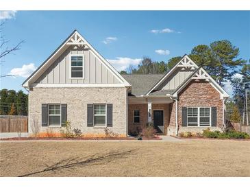Charming single-Gathering home with a combination brick and stone facade, complemented by neat landscaping at 2808 Blandwood Rd, Marietta, GA 30064