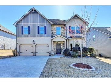 Charming two-story home featuring a well-manicured lawn, two-car garage, and inviting front entrance at 1465 Forest Brook Trl, Cumming, GA 30041