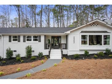 Charming brick home with white paint, black shutters, and a well-maintained landscaped front yard at 2302 Fairoaks Rd, Decatur, GA 30033