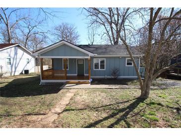 Charming light blue home featuring a cozy front porch and manicured lawn at 127 Marona Ne St, Atlanta, GA 30307