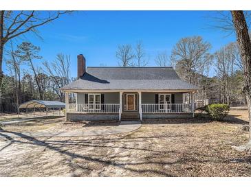 Charming single-story home featuring a covered front porch, neutral paint, and a well-maintained yard at 459 Rabbit Run, Mcdonough, GA 30252