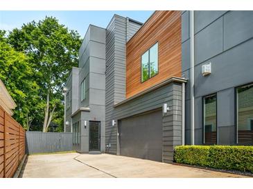 Modern two-story home featuring mixed siding, an attached garage, and a well-maintained lawn at 244 Locust Ne St # B, Atlanta, GA 30317