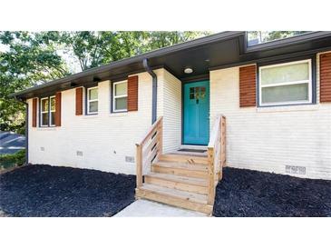 Inviting home featuring a brightly colored front door, wooden steps and a freshly mulched flower bed at 1300 Wichita Sw Dr, Atlanta, GA 30311