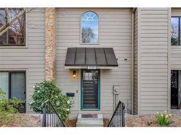 Charming home entrance with a well-kept lawn, attractive front door and covered entryway at 3721 Stonewall Se Cir, Atlanta, GA 30339