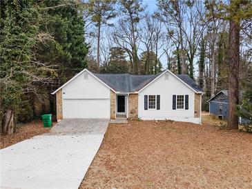 Charming one-story home with white siding, stone accents, and a well-manicured front yard at 2966 Knollberry Ln, Decatur, GA 30034