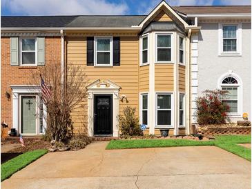 Charming townhome featuring a well-manicured front yard and inviting curb appeal at 4971 Jenny Dr, Acworth, GA 30101