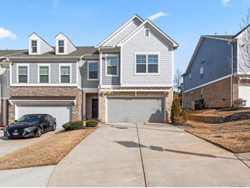 Beautiful two story townhome with a two car garage and inviting curb appeal at 130 Maple Creek Way, Woodstock, GA 30188