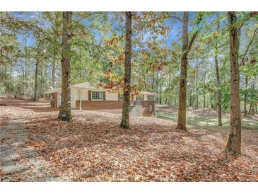 Quaint one-story house featuring a brick facade and cozy, traditional architecture at 7030 Cascade Palmetto Hwy, Palmetto, GA 30268