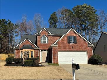 Charming two-story brick home featuring an attached two-car garage and well-maintained landscaping at 3004 Westray Nw Ct, Marietta, GA 30064