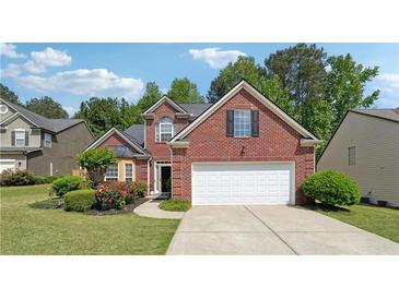 Charming brick home with an attached garage and a beautifully landscaped front yard at 3004 Westray Nw Ct, Marietta, GA 30064