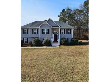 Charming two-story home featuring a welcoming entrance and well-maintained landscaping at 7603 Autumn Breeze, Douglasville, GA 30134